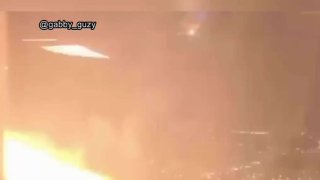 Fire appears outside a flight bound for Los Angeles in this image captured from a passenger’s video.