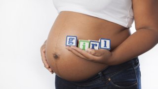 pregnant african american black woman its a girl shutterstock_207947656