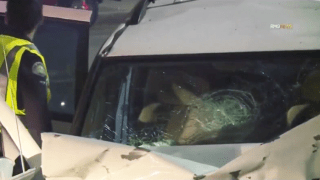 A cracked windshield on a white SUV after a crash