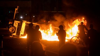 MINNEAPOLIS, MN - MAY 28: A surveillance camera burns in the parking lot of the Third Police Precinct on May 28, 2020 in Minneapolis, Minnesota. As unrest continues after the death of George Floyd police abandoned the precinct building, allowing protesters to set fire to it.