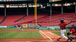 Andrew Benintendi #16 of the Boston Red Sox bats during a summer camp workout before the start of the 2020 Major League Baseball season on July 9, 2020 at Fenway Park in Boston, Massachusetts. The season was delayed due to the coronavirus pandemic.