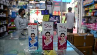 This photo taken on July 8, 2020 shows packages of Unilever "Fair and Lovely" skin-lightening creams on the counter of a shop in New Delhi. - Multinationals have long profited from sales of whitening creams, facewash and even vaginal bleaching lotions, by advertising the message that beauty, success and love are only for pale-skinned people. Now, companies like Unilever say they "want to lead the celebration of a more diverse portrayal of beauty".