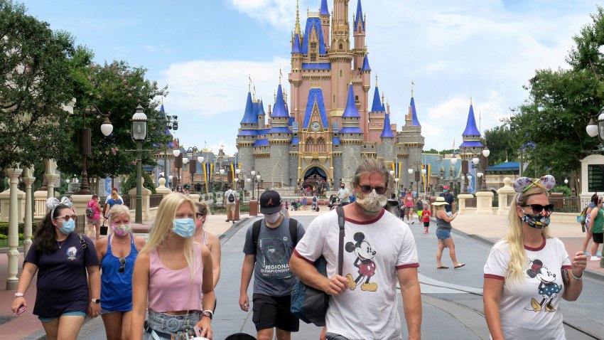 Guests wear masks. as required. to attend the official re-opening day of the Magic Kingdom at Walt Disney World in Lake Buena Vista, Florida, on Saturday, July 11, 2020. Disney opened two Florida parks, the Magic Kingdom and Animal Kingdom, Saturday with limited capacity and safety protocols in place in response to the Coronavirus pandenmic.