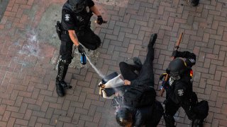 Police disperse demonstrators with pepper spray during protests in Seattle on July 25, 2020 in Seattle, Washington. Police and demonstrators clash as protests continue in the city following reports that federal agents may have been sent to the city.