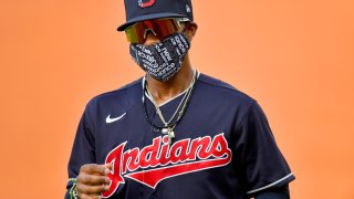Francisco Lindor #12 of the Cleveland Indians warms up on the field wearing a face mask prior to an intrasquad game during summer workouts at Progressive Field on July 09, 2020 in Cleveland, Ohio.