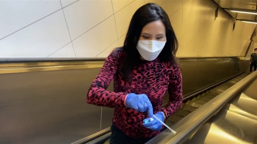 NBC News' Vicky Nguyen swabs an escalator.