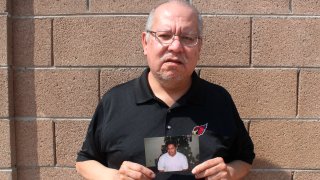 Auska Mitchell holds a photograph of his nephew, Lezmond Mitchell, on Friday, Aug. 21, 2020, in the Phoenix area. Lezmond Mitchell is scheduled to be executed Wednesday, Aug. 26, and the Navajo government is pushing to spare his life on the basis of cultural beliefs and sovereignty.