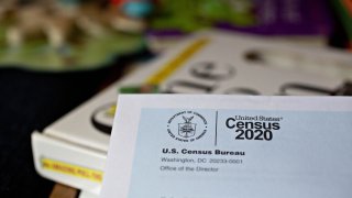In this March 24, 2020, file photo, a U.S. Census 2020 invitation is arranged for a photograph in Arlington, Virginia.