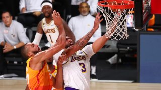 Anthony Davis #3 of the Los Angeles Lakers is fouled on a drive to the basket by Rudy Gobert #27 of the Utah Jazz during the first half of an NBA game at The Arena at ESPN Wide World Of Sports Complex on August 3, 2020 in Lake Buena Vista, Florida.