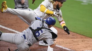 Fernando Tatis Jr. #23 of the San Diego Padres collides with catcher Will Smith #16 of the Los Angeles Dodgers as he’s tagged out at the plate during the seventh inning of a baseball game at Petco Park August 3, 2020 in San Diego, California. (Photo by Denis Poroy/Getty Images)