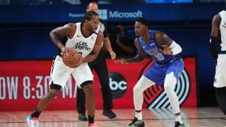Kawhi Leonard #2 of the LA Clippers handles the ball against the Dallas Mavericks during Round One, Game One of the NBA Playoffs on August 21, 2020 in Orlando, Florida at AdventHealth Arena.