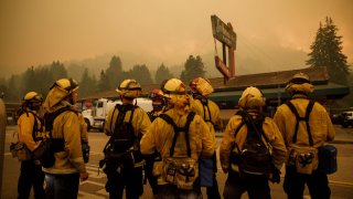 Volunteer firefighters for the Boulder Creek Fire District and look at the direction of the fire before they are dispatched to battle the CZU August Lightning Complex fire on Aug. 20, 2020, in Boulder Creek, Calif. (Photo by Dai Sugano/MediaNews Group/The Mercury News via Getty Images)