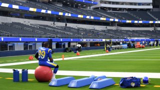 A Rams player in an empty stadium.