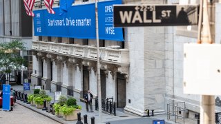 NEW YORK, NEW YORK - AUGUST 27: A stock trader wearing a mask walks near social distancing signs the day a new IPO is launched at the New York Stock Exchange as the city continues Phase 4 of re-opening following restrictions imposed to slow the spread of coronavirus on August 27, 2020 in New York City. The fourth phase allows outdoor arts and entertainment, sporting events without fans and media production.