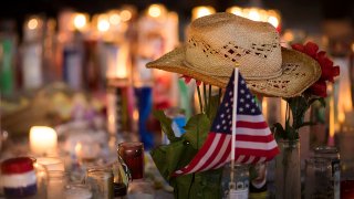 A hat is left at a makeshift memorial during a vigil to mark one week since the mass shooting at the Route 91 Harvest country music festival.