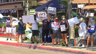 Protests rally in support of the United States Postal Service on Saturday, Aug. 22, 2020 in San Diego.