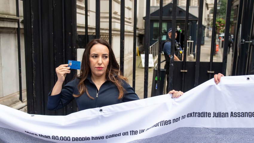 Partner of Wikileaks founder Julian Assange, Stella Moris, holds up a Julian Assange press card outside the gates of Downing Street, in Westminster, London, after attempting to deliver a Reporters Without Borders petition against the extradition of her partner to the US. Lawyers for Assange and the U.S. government will face off in London on Monday at an extradition hearing that was delayed by the coronavirus pandemic.