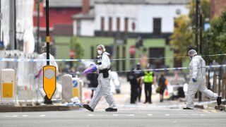 Police forensic officers investigate after stabbings in Birmingham, northern England, Sunday Sept. 6, 2020.