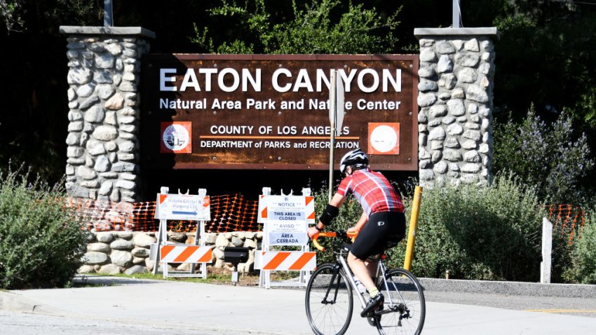 A cyclist rides past the closed Eaton Canyon Natural Area Park and nature Center.