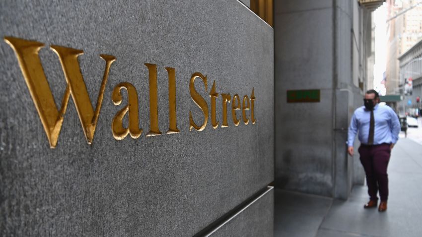 A man walks near the New York Stock Exchange (NYSE) on August 31, 2020 at Wall Street in New York City. - Wall Street stocks paused near record levels early Monday ahead of key economic data later in the week, with a newly-tweaked Dow index edging lower. The final session of a heady August opened on a lackluster note as markets await employment data and updates on the manufacturing and services sectors in the coming days. About 15 minutes into trading, the Dow Jones Industrial Average was down 0.4 percent to 28,539.83.