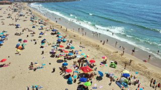 People gather at the beach during a September heat wave.