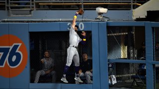 Sam Hilliard #22 Colorado Rockies leaps and catches the ball in front of the bullpen to deny a home run by Cody Bellinger #35 of the Los Angeles Dodgers during the fourth inning at Dodger Stadium on September 5, 2020 in Los Angeles, California. (Photo by Kevork Djansezian/Getty Images)