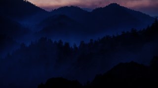 Smoke settles as ash filters the sunset looking west from Angeles Crest Highway.