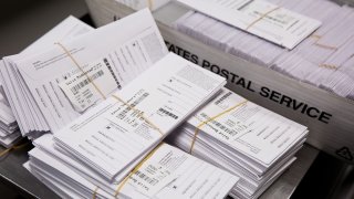 Sample voting ballots sit in a pile