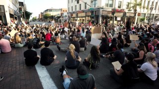 Demonstrators protest and occupy the intersection of Colorado Blvd and Fair Oaks Ave. after the death of George Floyd, a black man who was in police custody in Minneapolis in Pasadena on Thursday, June 4, 2020.
