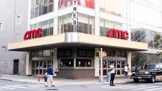 In this Aug. 30, 2020, file photo, people walk outside of the AMC movie theater in the East Village in the East Village as the city continues Phase 4 of re-opening following restrictions imposed to slow the spread of coronavirus in New York City.