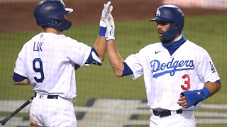 Chris Taylor #3 of the Los Angeles Dodgers celebrates his run with Gavin Lux #9, off an Edwin Rios #43 sacrifice fly, to take a 4-1 lead over the Arizona Diamondbacks during the fifth inning against the Arizona Diamondbacks at Dodger Stadium on September 01, 2020 in Los Angeles, California. (Photo by Harry How/Getty Images)