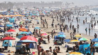 People gather on the beach at the Pacific Ocean on the first day of the Labor Day weekend amid a heat wave on September 5, 2020 in Santa Monica, California.