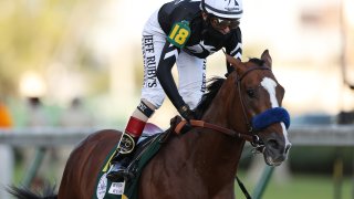 John Velazquez celebrates atop Authentic, #18, after winning the 146th running of the Kentucky Derby at Churchill Downs on Sept. 5, 2020 in Louisville, Kentucky.