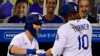 Cody Bellinger #35 of the Los Angeles Dodgers celebrates the solo homerun of Justin Turner #10, to trail 5-4 to the Los Angeles Angels, during the fifth inning at Dodger Stadium on September 25, 2020 in Los Angeles, California. (Photo by Harry How/Getty Images)