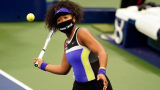 Naomi Osaka, of Japan, wears a mask in honor of Breonna Taylor as she celebrates after defeating Misaki Doi, of Japan, during the first round of the US Open tennis championships, Monday, Aug. 31, 2020, in New York.