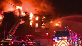 Fire burns an apartment building under construction.