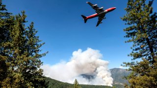 FILE – In this Sept. 17, 2020, file photo, an air tanker prepares to drop retardant while battling the August Complex Fire in the Mendocino National Forest, Calif.