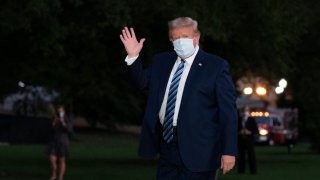 President Donald Trump waves as he returns to the White House Monday, Oct. 5, 2020, in Washington, after leaving Walter Reed National Military Medical Center, in Bethesda, Md. Trump announced he tested positive for COVID-19 on Oct. 2.