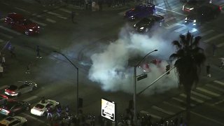 Car doing doughnuts in Los Angeles during a celebration for the LA Dodgers’ World Series win.