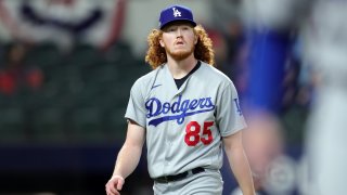Dustin May #85 of the Los Angeles Dodgers walks off the field after the first inning of Game 5 of the NLCS between the Atlanta Braves and the Los Angeles Dodgers at Globe Life Field on Friday, October 16, 2020 in Arlington, Texas.