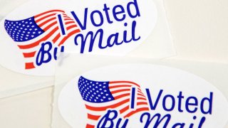 In this Sept. 4, 2020, file photo, stickers that read "I Voted By Mail" sit on a table waiting to be stuffed into envelopes by absentee ballot election workers at the Mecklenburg County Board of Elections office in Charlotte, North Carolina.