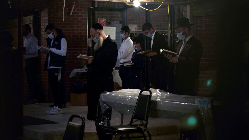 Members of the Sephardic Jewish Community pray in a temple despite the prohibition of large gatherings in Brooklyn, New York as others gather to protest Mayor Bill Deblasio's closing of businesses and new lockdown in their neighborhood on October 8, 2020.