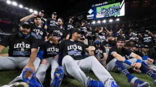 The Los Angeles Dodgers celebrate with a team photo on the field after a 12-3 win in Game 3 of the NLDS between the Los Angeles Dodgers and the San Diego Padres at Globe Life Field on Thursday, October 8, 2020 in Arlington, Texas.
