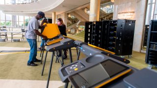 A man sets up at a vote center.