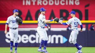 Cody Bellinger #35 of the Los Angeles Dodgers celebrates with Mookie Betts #50 and Chris Taylor #3 after the Dodgers won Game 3 of the 2020 World Series against the Tampa Bay Rays at Globe Life Field on Friday, October 23, 2020 in Arlington, Texas. (Photo by Kelly Gavin/MLB Photos via Getty Images)
