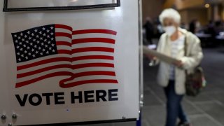 A voter walks towards a booth to fill out her ballot during the in-person early voting at a polling station in Lincoln Center in New York, the United States, Oct. 24, 2020. Early voting began across New York State on Saturday, offering voters nine days to cast their ballots prior to Election Day.