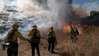 CHINO HILLS, CA – OCTOBER 27: Firefighters set a backfire to protect homes and try to contain the Blue Ridge Fire on October 27, 2020 in Chino Hills, California. Strong Santa Ana Winds gusting to more than 90 miles per hour have driven the Blue Ridge Fire and Silverado Fire across thousands of acres, grounding firefighting aircraft, forcing tens of thousands of people to flee, and gravely injuring two firefighters. More than 8,200 wildfires have burned across a record 4 million-plus acres so far this year, more than double the previous record. (Photo by David McNew/Getty Images)