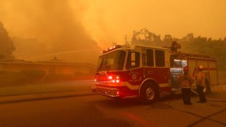 SANTA ROSA, CALIFORNIA – SEPTEMBER 28: Firefighters pour water on a burning structure after the Glass Incident moved through the Oakmont neighborhood on September 28, 2020 in Santa Rosa, California. The fast-moving Glass Incident, originally called the Glass Fire, has burned over 11,000 acres in Sonoma and Napa counties. The fire is zero percent contained. Much of Northern California is under a red flag warning for high fire danger through Monday evening. (Photo by Justin Sullivan/Getty Images)