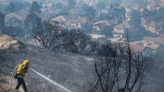 Firefighters protect homes.