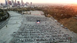 An aerial view of baseball fans attending a drive-in screening of Game 6.